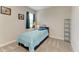 Cozy bedroom with a twin bed, neutral carpet, a window with blinds, and simple decor at 10609 Great Cormorant Dr, Riverview, FL 33579