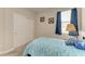 Simple bedroom with a twin bed, a window with curtains, and a closet for storage at 10609 Great Cormorant Dr, Riverview, FL 33579
