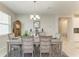 Dining area boasting natural light, a decorative grandfather clock, and seamless access to other rooms at 10609 Great Cormorant Dr, Riverview, FL 33579