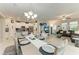Open-concept dining area with elegant chandelier, connecting to the kitchen and living room at 10609 Great Cormorant Dr, Riverview, FL 33579