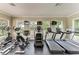 Well-equipped fitness center featuring treadmills, elliptical machines, and televisions for entertainment at 10609 Great Cormorant Dr, Riverview, FL 33579