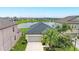 Lovely home featuring a well-manicured lawn and a serene lake view at 10609 Great Cormorant Dr, Riverview, FL 33579