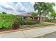 Charming exterior of home featuring manicured landscaping, vibrant plants, and a well-maintained lawn at 10609 Great Cormorant Dr, Riverview, FL 33579