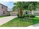 Charming single-Gathering home with beautiful landscaping, a stone facade, and a paved driveway at 10609 Great Cormorant Dr, Riverview, FL 33579