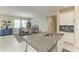 Open kitchen view featuring granite countertops, modern appliances, and a seamless transition to the dining area at 10609 Great Cormorant Dr, Riverview, FL 33579