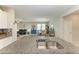 Open concept kitchen with granite countertops, stainless steel sink, and flows into the living and dining area at 10609 Great Cormorant Dr, Riverview, FL 33579