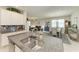 Open concept kitchen with granite countertops, stainless steel sink, and flows into the living and dining area at 10609 Great Cormorant Dr, Riverview, FL 33579