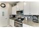 Well-equipped kitchen with granite counters, backsplash, and modern appliances, ideal for cooking enthusiasts at 10609 Great Cormorant Dr, Riverview, FL 33579