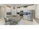 Bright kitchen features granite counters, stainless steel appliances, and a central island with seating at 10609 Great Cormorant Dr, Riverview, FL 33579