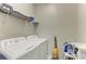 Functional laundry room with a washer, dryer, and storage shelves for supplies at 10609 Great Cormorant Dr, Riverview, FL 33579