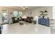 Bright and airy living room featuring stylish furnishings, tile floors, and access to the lanai at 10609 Great Cormorant Dr, Riverview, FL 33579