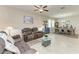 Inviting living room with tile floors and neutral colors leading into the dining area, perfect for gatherings at 10609 Great Cormorant Dr, Riverview, FL 33579