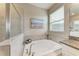Soaking tub in main bathroom with separate shower and marble surround at 10609 Great Cormorant Dr, Riverview, FL 33579