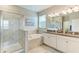 Main bathroom with dual sinks, granite counters, shower and soaking tub at 10609 Great Cormorant Dr, Riverview, FL 33579
