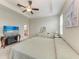 Bright main bedroom with ceiling fan, TV, and ensuite bathroom at 10609 Great Cormorant Dr, Riverview, FL 33579