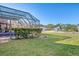 Backyard with green grass and screened-in pool view at 1144 Hoover St, Nokomis, FL 34275