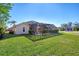 Backyard with view of home and the screened-in pool at 1144 Hoover St, Nokomis, FL 34275