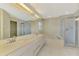 Well-lit bathroom featuring double sinks, soaking tub, and separate glass-enclosed shower at 1144 Hoover St, Nokomis, FL 34275