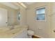 Cozy half bath featuring elegant butterfly wallpaper, a window, and vanity with sink at 1144 Hoover St, Nokomis, FL 34275