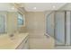 Bright bathroom featuring a soaking tub with marble surround, shower, and ample vanity space at 1144 Hoover St, Nokomis, FL 34275