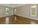 Spacious bedroom with wood-look tile flooring and windows providing natural light at 1144 Hoover St, Nokomis, FL 34275