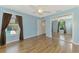 Bright bedroom with wood-look floors, pool view, mirrored closet, and ceiling fan at 1144 Hoover St, Nokomis, FL 34275