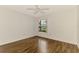 Clean bedroom with warm wood-look floors and a window letting in natural light at 1144 Hoover St, Nokomis, FL 34275
