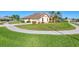 Expansive corner lot featuring a lush lawn and mature landscaping wrapping around the home's exterior at 1144 Hoover St, Nokomis, FL 34275