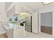 Bright kitchen features white cabinets, stainless steel refrigerator, and an eat-in bar at 1144 Hoover St, Nokomis, FL 34275