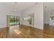 Living room featuring wood-look tile floors, ceiling fan, and an open view to the kitchen at 1144 Hoover St, Nokomis, FL 34275