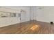 Living room features wood-look tile floors with a partial view of the kitchen and dining area at 1144 Hoover St, Nokomis, FL 34275