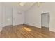 Bright room with wood-look tile floors, a ceiling fan, and access to other rooms at 1144 Hoover St, Nokomis, FL 34275
