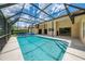 Wide view of the screened-in pool and exterior at 1144 Hoover St, Nokomis, FL 34275