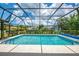 Aerial view of the screened-in pool area with green landscaping at 1144 Hoover St, Nokomis, FL 34275