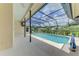 Screened-in pool area with a view of green landscaping at 1144 Hoover St, Nokomis, FL 34275
