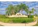 Signage for the Laurel Woodlands community with palm trees at 1144 Hoover St, Nokomis, FL 34275