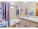 Cozy bathroom featuring a tub with a shower, a white vanity and classic wallpaper design at 1163 Nantucket Rd, Venice, FL 34293