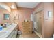 Bathroom featuring double sinks, a large mirror, and a glass-enclosed shower at 1163 Nantucket Rd, Venice, FL 34293