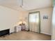 Bright, empty bedroom with large windows, neutral decor, and a ceiling fan at 1163 Nantucket Rd, Venice, FL 34293