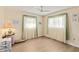 Bright bedroom with hardwood floors, ceiling fan, and natural light streaming through the windows at 1163 Nantucket Rd, Venice, FL 34293
