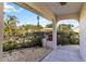 Inviting front porch with stone flooring and lush landscaping creates a welcoming entrance to this charming home at 1163 Nantucket Rd, Venice, FL 34293