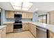 Bright kitchen featuring stainless steel appliances, lots of counter space, wood cabinets and a garden view at 1163 Nantucket Rd, Venice, FL 34293