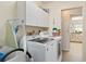 Convenient laundry room featuring a full-size washer and dryer with extra cabinet storage space at 1163 Nantucket Rd, Venice, FL 34293