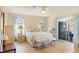 Light-filled main bedroom with a large window, light curtains, and soft, neutral decor at 1163 Nantucket Rd, Venice, FL 34293