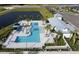Aerial view showcasing a community pool area and landscaping next to a pond at 11685 Great Brook Ln, Parrish, FL 34219