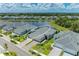 Aerial view of a lakeside neighborhood featuring a home with a brick driveway at 11685 Great Brook Ln, Parrish, FL 34219