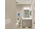 This half-bathroom features a toilet, a sink, and storage space below the sink at 11685 Great Brook Ln, Parrish, FL 34219