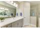This bathroom features double sinks, modern lighting, and a glass-enclosed shower at 11685 Great Brook Ln, Parrish, FL 34219