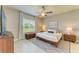Cozy bedroom featuring a ceiling fan, natural light, and modern decor at 11685 Great Brook Ln, Parrish, FL 34219