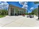 Modern community center with large windows, outdoor seating, and ample parking at 11685 Great Brook Ln, Parrish, FL 34219